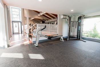 a home gym with a treadmill in the corner of a room